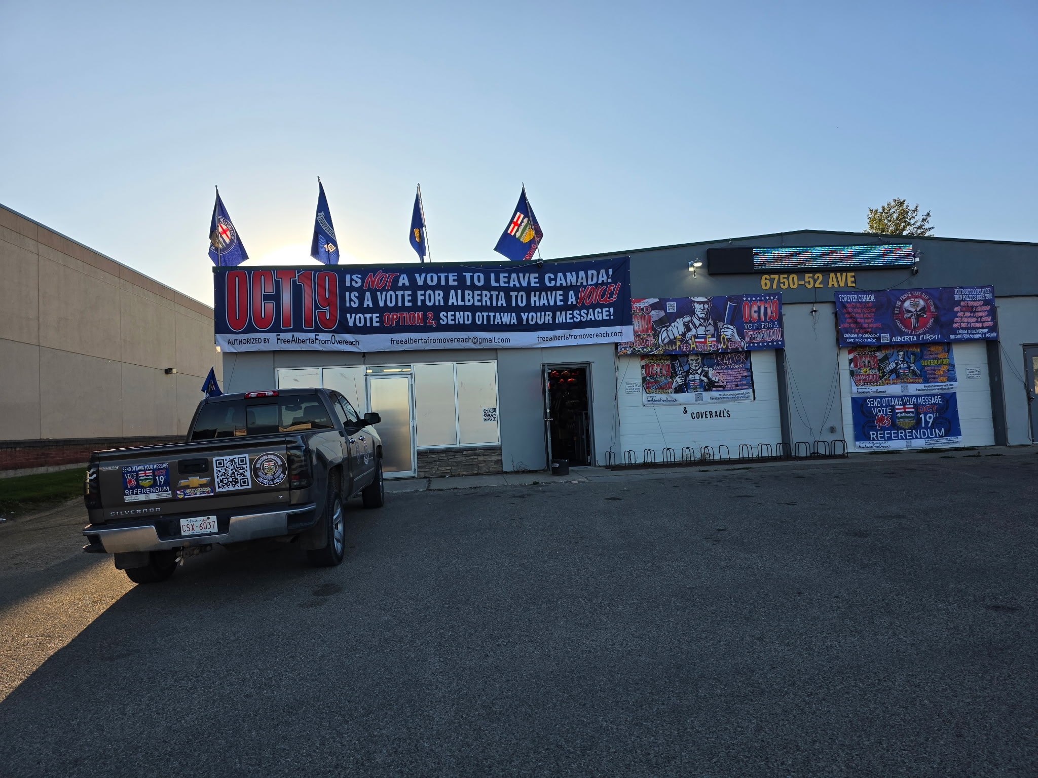 Oct 19 is Not a Vote to Leave Canada storefront banner with Alberta flags and Silverado truck