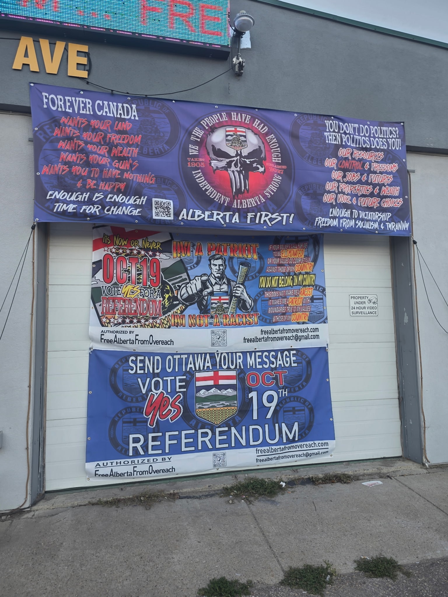 Multiple campaign banners on storefront — Red Deer