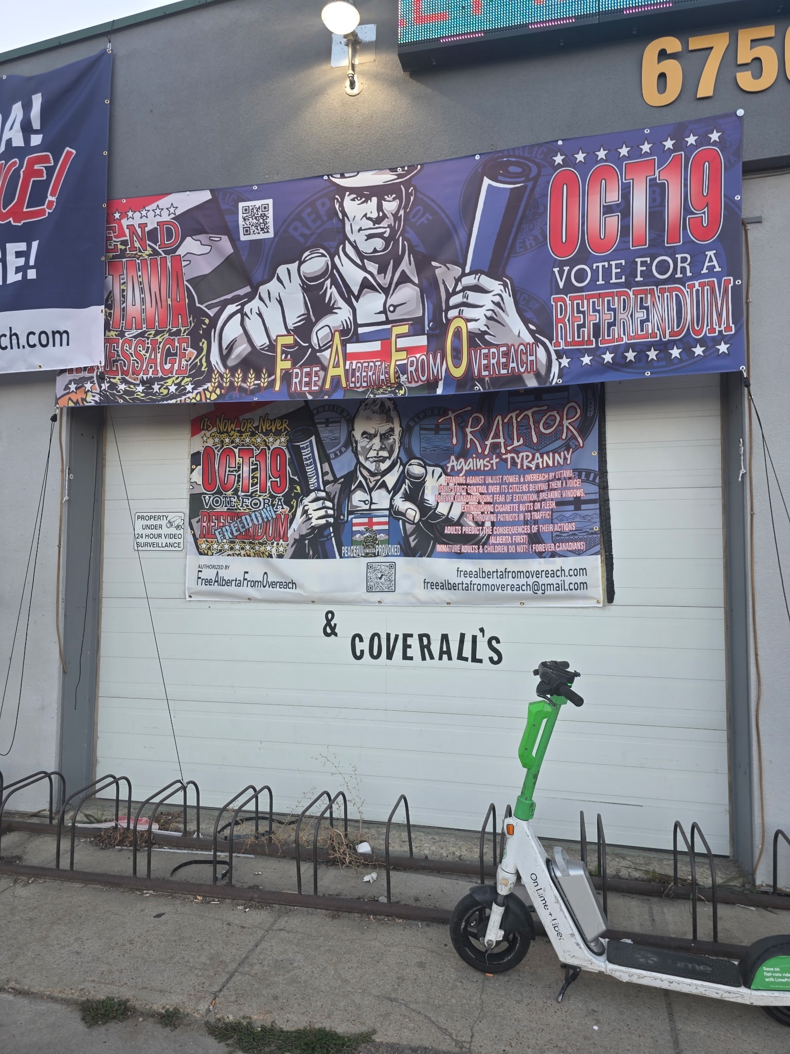 FAFO and referendum banners on storefront with scooter